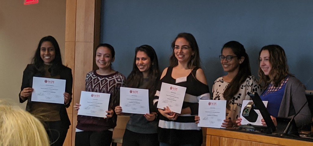 WRAMP cohort holding Worcester Polytechnic Institute certificates of completion